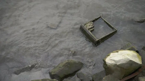 Discarded computer case on a riverbank Stock Footage 64658706
