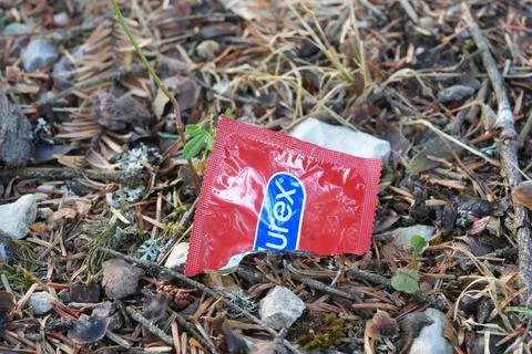 Discarded Durex Condom Wrapper on Forest Floor Stock Photos