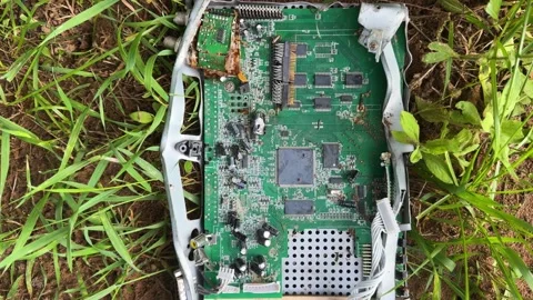 Discarded electronic circuit boards on the grass, environmental pollution  Stock Footage 337064136