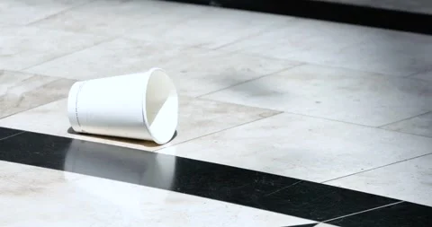 A discarded empty cup on the floor of a shopping center. Environmental prote Stock Footage 342760774