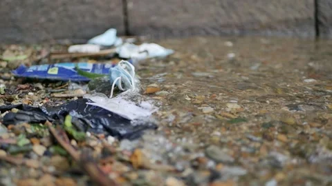 Discarded Face Mask gets washed ashore by the sea tide. Stock Footage 152956927