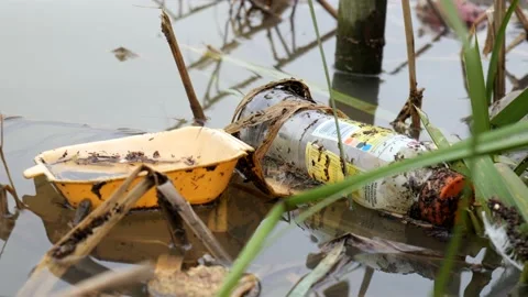 Discarded food packaging floating in river water Stock Footage 147755045