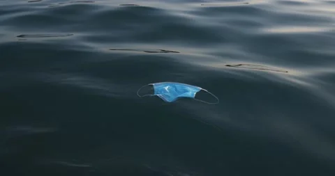 Discarded mask with floating on ocean surface Stock Footage 145429168