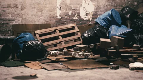 Discarded materials and trash pile in an abandoned warehouse setting Stock Footage 308529328