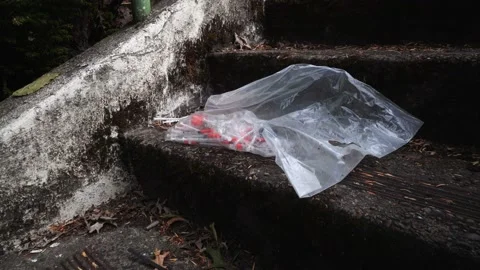 Discarded Needles on Sidewalk Stock Footage