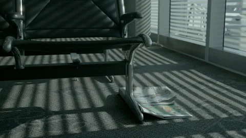Discarded Newspaper Under Empty Airport Chairs 库存影片 343881955
