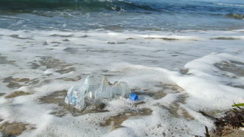 Discarded plastic bottle float over sea waves, environment pollution,slowmotion Video stock 230737633