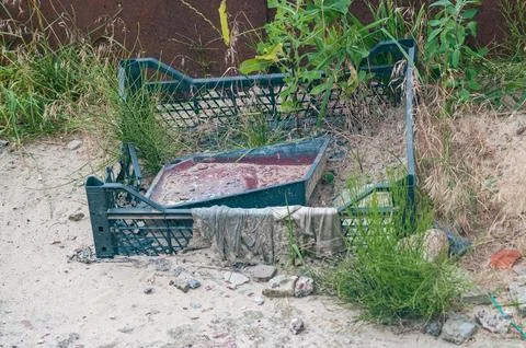 Discarded Plastic Crate and Rubble in Sandy Ground Stock Photos