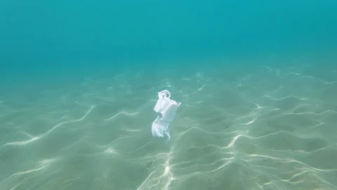 Discarded plastic cup floating on contaminated sea ecosystem,nature pollution Stock Footage 157942879
