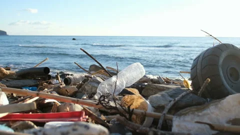 Discarded plastic trash pollution on sea coast ecosystem,environmental waste Stock Footage 148587896