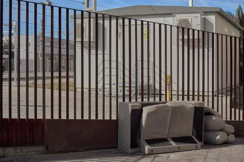 Discarded sofa left out on the sidewalk. Stock Photos
