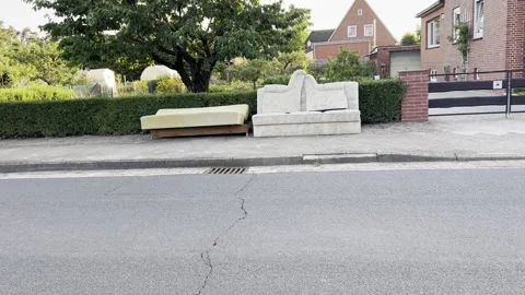 Discarded Sofa Sections Awaiting Sperrmüll Pickup in German Neighborhood Stock Footage 340636767