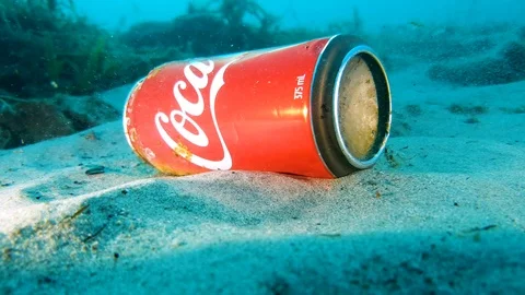 A discarded soft drink can being picked up from the ocean floor during a Stock Footage 108409420