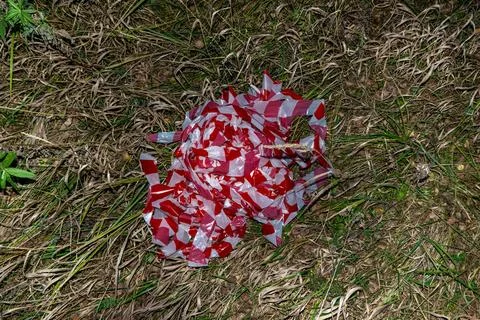 Discarded warning tape indicates environmental negligence and potential wildlife Stock Photos
