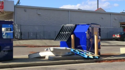 Discarded waste and large items by a dumpster in an urban area Stock Footage 144224155