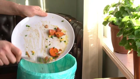 Discarding Leftover Food into Trash Stock Footage 299683011