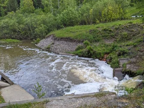 Discharge of water into the river Stock Photos