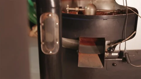 Discharging cooled roasted coffee beans from the machine Stock Footage 334732424