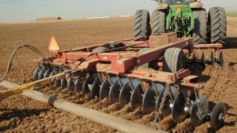 Discing Tractor drives close by Stock Footage 94643131