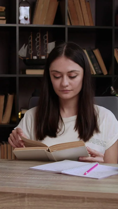 Disciplinary student seeks information from old specialized literature. Young Video stock 305408300