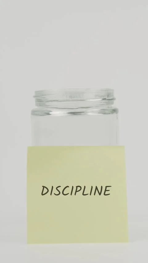 Discipline text or word on yellow sticky note attached to glass jar Stock Footage 311719156