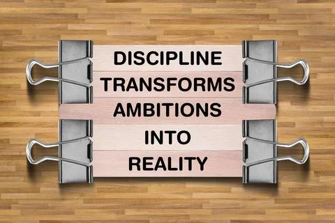 Discipline Transforms Ambitions Into Reality written on wooden stick Stock Photos