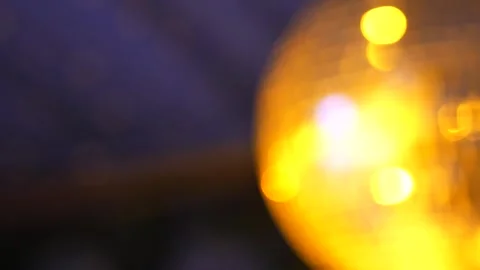 A disco ball Blurred spins and reflects bright lights during a celebratory dance Stock Footage 326832308