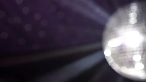 A disco ball Blurred spins and reflects bright lights during a celebratory dance Stock Footage 339179800