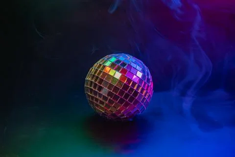 Disco ball with bokeh effect, reflecting colorful lights, symbolizing party a Stock Photos