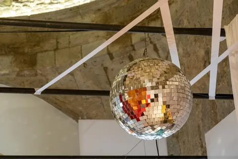 Disco ball with bright rays, night party background photo concrete ceiling Stock Photos