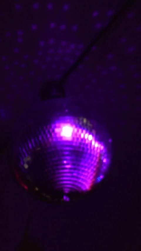 Disco Ball Hanging from Ceiling with Blue Purple Party Lights Stock Footage 337902735