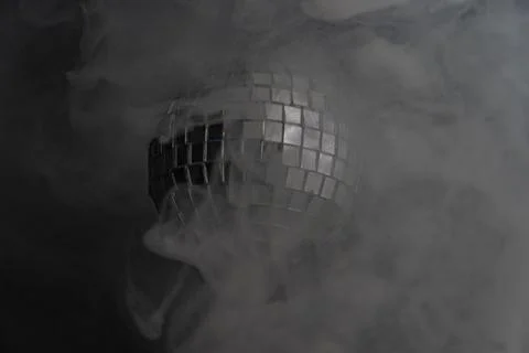 Disco ball image with misty background, suggesting a lively celebration or pa Stock Photos