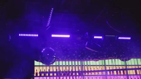 Disco ball with multicolored rays on the background of a bar counter in a Stock Footage 170183633
