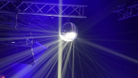 Disco ball reflecting beams of light in a studio setting 库存影片 298605148