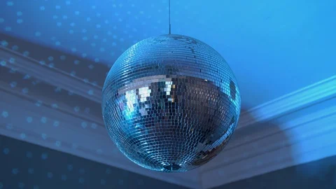 Disco ball rotating in the apartment, glare of blue light throughout the room Stock Footage 129664802