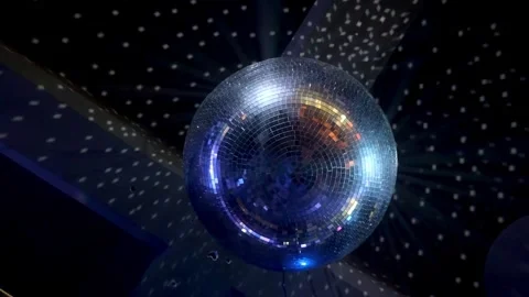 A disco ball rotating on the ceiling of the night club and reflects rays of Stockbeeldmateriaal 289387528