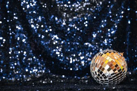 Disco ball on sequin background Stock Photos