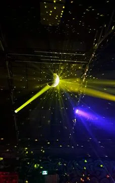 A disco ball shining in the light beam in a club Stock Photos