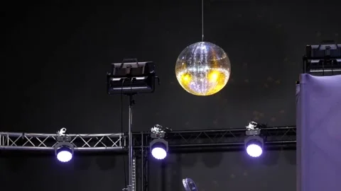 Disco ball spinning on the background of the light guide device Stock Footage 153108796