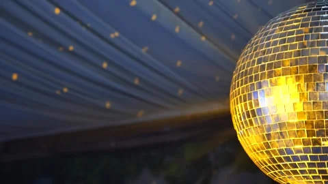Disco ball spins and reflects bright lights during a celebratory dance event Stock Footage 326832307