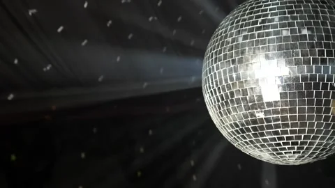 Disco ball spins and reflects bright lights during a celebratory dance event Stock Footage 331212875