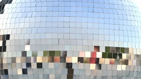 Disco ball surface reflecting light and colors, creating a vibrant party Stock Footage 344697843