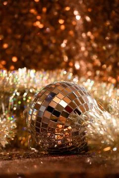 Disco ball in tisel on sequin background Stock Photos
