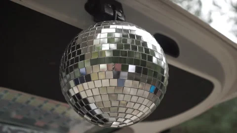 Disco ball under the hood of the car. Footage. Concept video. Close-up. Stockbeeldmateriaal 153511368