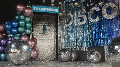 Disco balls against the background of shiny disco lettering and a telephone Stock Footage 266413377