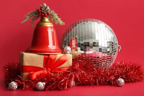 Disco balls, gift box and Christmas decor on red background, closeup Stock Photos