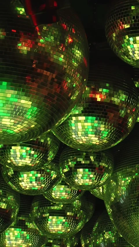 Disco balls reflect vibrant lights at night, adding energy to parties Stock Footage 276355442