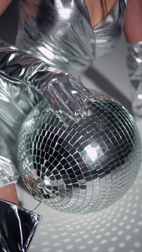 Disco Glamour in Silver. Close-up of woman's hands on a disco ball, silver theme Stock Footage 267908098