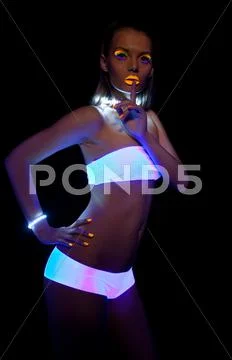Disco sexy girl with glow make-up silence sign Stock Photos