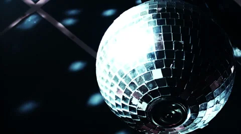 Discoball mirrorball spinning reflecting light into a club venue Stock Footage 52056571